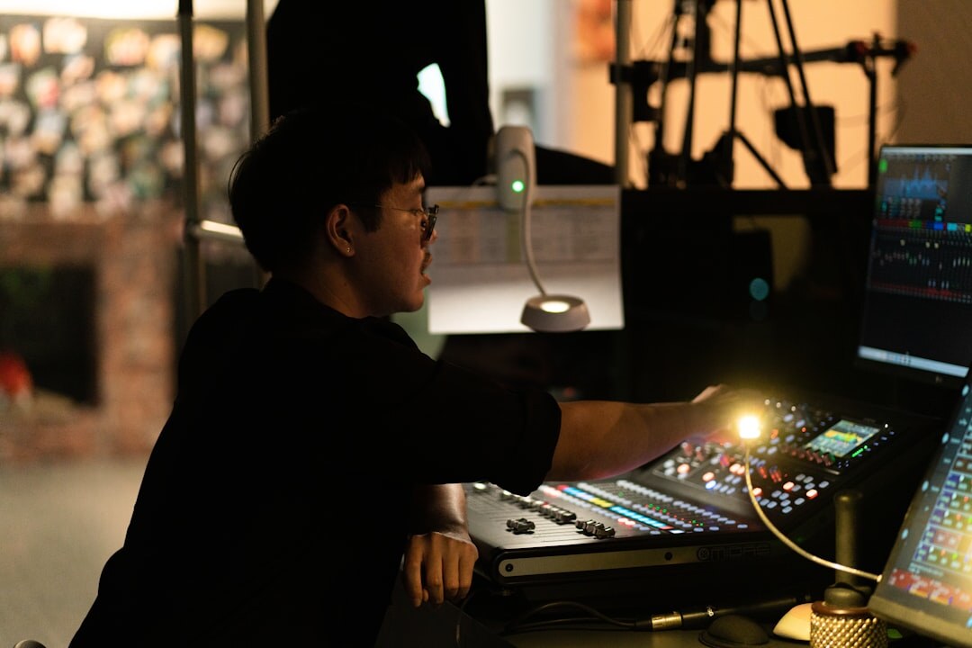Sound engineer working at a large mixing console in a studio